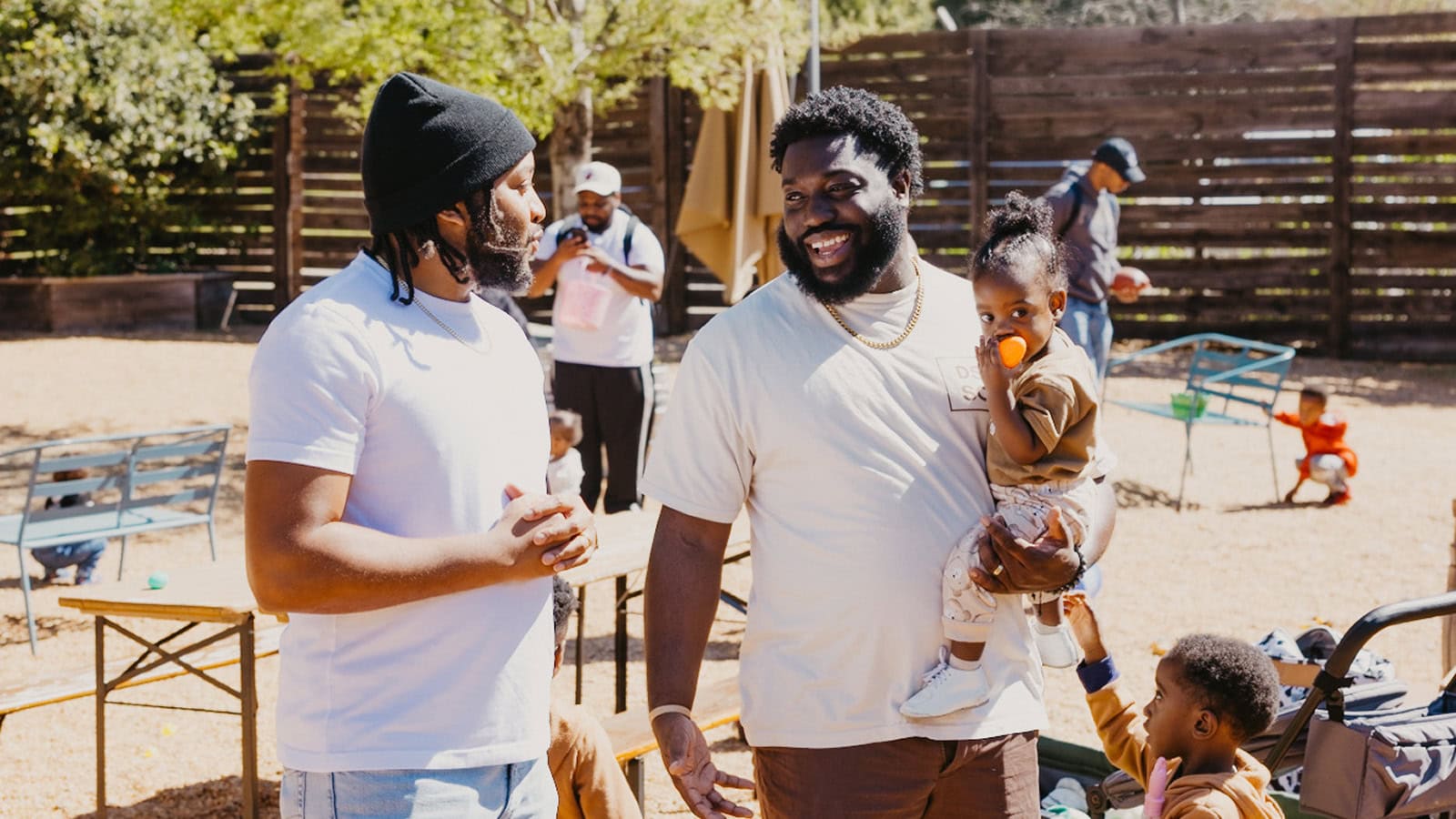 Two dads talk at a fatherhood support event at Daddy Stroller Social Club