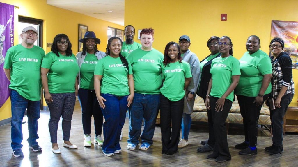 Ten Forest Park residents pose at a monthly grantmaking meeting to decide how to invest in their local community