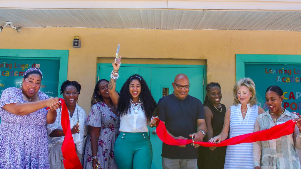 Alana Dorsey cuts the ribbon to celebrate her newly renovated early learning center with partners from United Way of Greater Atlanta, PAACT, Quality Care for Children, Early Learning Property Management, and Banner Services Group.